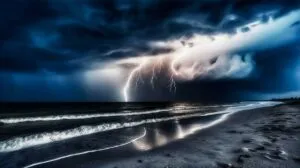 lighting in distance over ocean and sandy beach