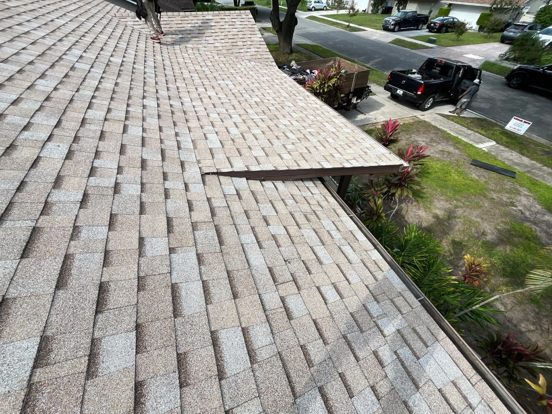 new shingle roof in Florida on home with royalty roof workers cleaning up