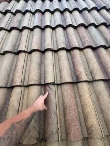pointing at damage on a tile roof
