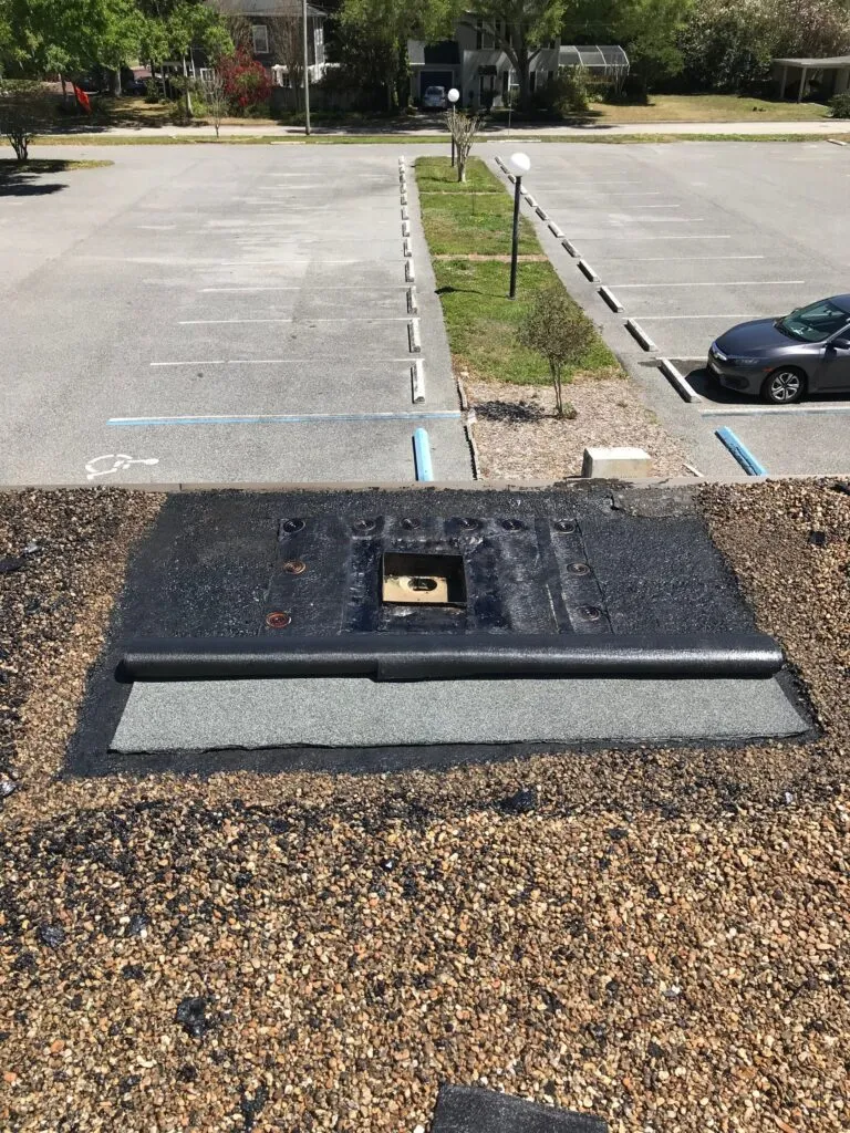 showing repair process on a BUR roof on a church around an area that allowed leaks