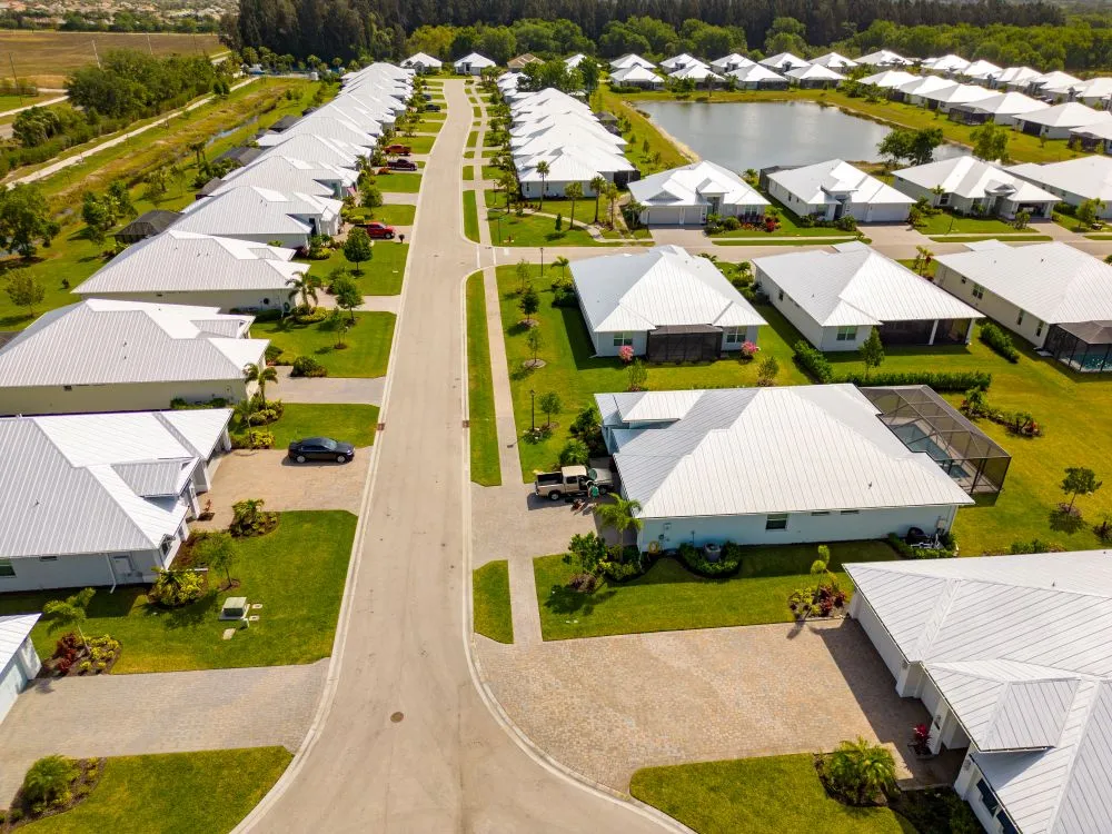 drone shot of metal roofs on houses in suburb of florida